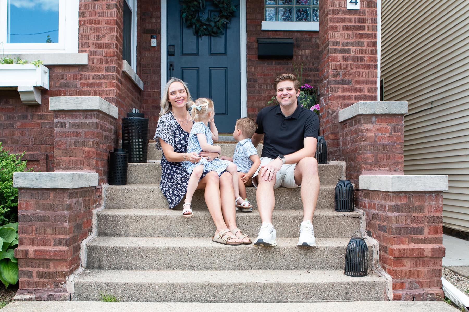 Our family sitting on the front porch of our home