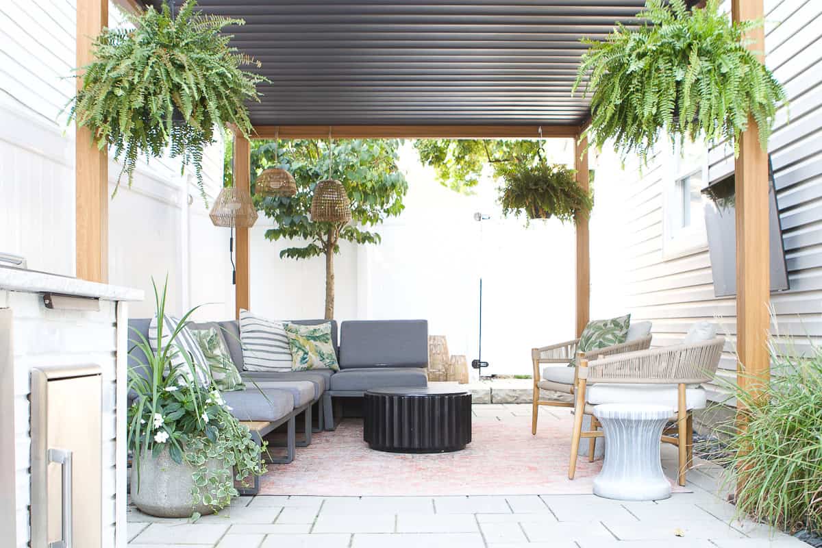 Our backyard with a lounge area underneath the pergola